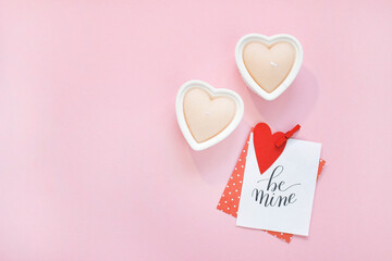Happy Valentines Day composition. Blank greeting card mockup, gift boxes, red hearts, confetti on pink background