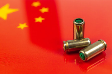 Gun bullets over the China flag. Criminal and corruption concept. Outlaw, ghetto, social problem and armed attack background photo