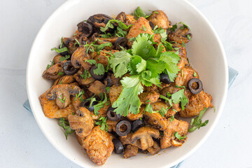 Mushroom Chicken Stir Fry in a Bowl Garnished with Cilantro
