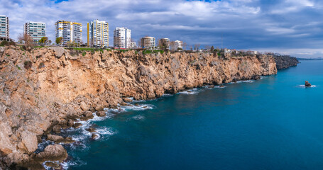 Panorama View of the Falezler region in Antalya Turkey, High cliffs facing towards the Mediterranean on Blue Cloudy Day, The landscape of turquoise teal and a dramatically cloudy sky.