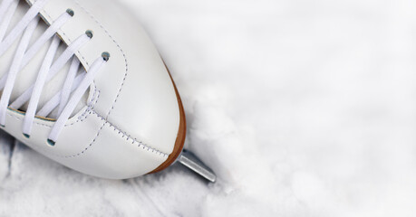 White figure skate on the snow.