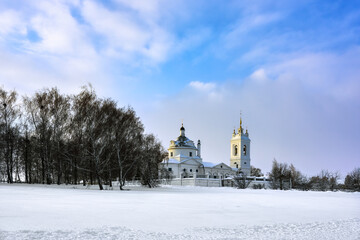 Fototapeta na wymiar Winter view from the Oka River to the village of Konstantinovo and the church.