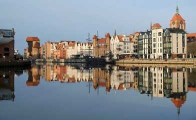 Panorama of Old Town in Gdansk and Motlawa river with ships, Poland. Amazing reflections in water.