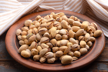 Pistachios, pistachios on a wooden plate