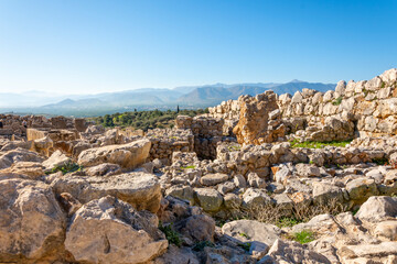 Fototapeta na wymiar Ancient Greek ruins overlooking the valleys and hills of the Peloponnese at the archaeological site of Mycenae, Greece.