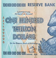 The text is onehundred trillion dollars close up on a Zimbabwe banknote.