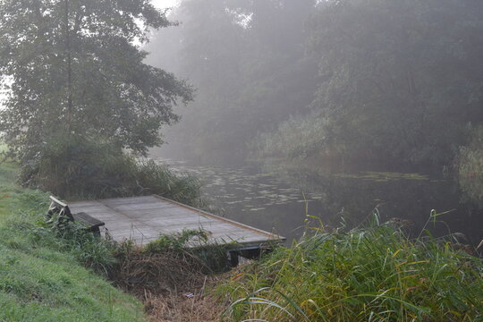 fishing spot in the Dedemsvaart canal on a misty morning in autumn