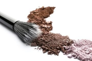 Makeup brush and loose eye shadow on white background