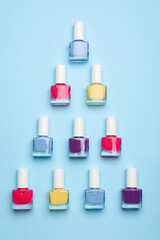 Set of nail polish bottles on color background
