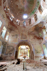 Exit from the middle part of the old destroyed Orthodox church in Russia. Exit in the center. Peeling paint and old red bricks. Symmetry. Daylight.