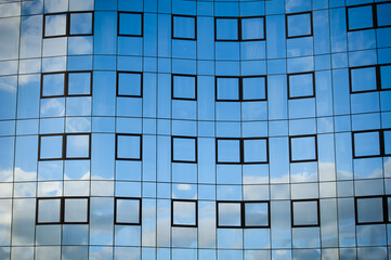 Clouds reflected in the glass facade of building