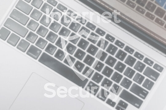 Data protecting security concept. Computer Internet protection symbol on blured keyboard background. Hacker attack and data breach, information leak concept.