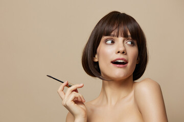 Obraz premium beautiful woman eyelash brush model makeup posing isolated background