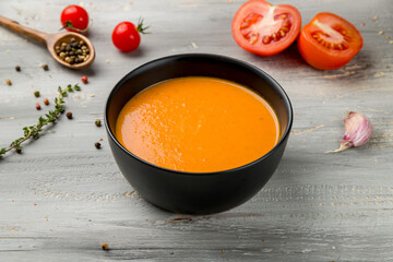 Soup cream of pumpkin on grey wooden table