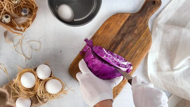 Natural coloring Easter eggs with red cabbage. Chef cuts red cabbage into slices