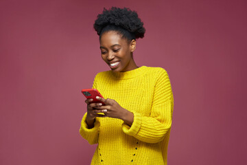 Happy toothy smiling african american girl using phone mobile applications, browsing social...