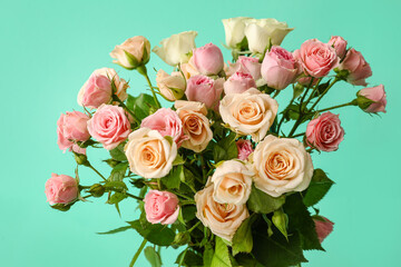 Bouquet of beautiful small roses on green background