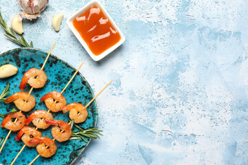 Plate with grilled shrimp skewers and sauce on blue background, closeup