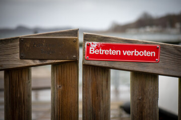 on red sign at a gate is written in german: Betreten verboten