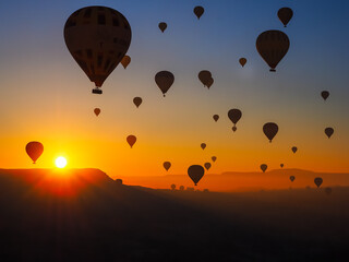 Silhouette of hot air balloons in sky at sunrise nature background above the mountains at Cappadocia.