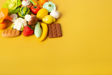vegetables, fruits and sweets from polymer clay on a yellow background