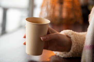 Obraz na płótnie Canvas cup of coffee with a hand