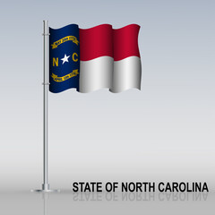 Flag of State of North Carolina (USA) flying on a flagpole stands on the table.