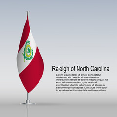 Flag of Raleigh in North Carolina (USA) hanging on a flagpole stands on the table
