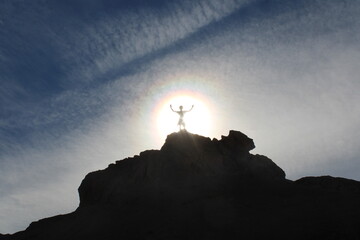silhouette of a person on the top of mountain