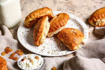 Plate of tasty sochniki with cottage cheese on beige background