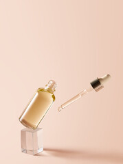 Essential oil in a glass dropper bottle and a pipette with dripping oil. Herbal cosmetic, natural organic beauty product