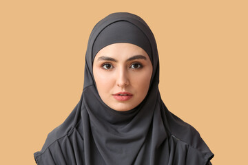 Naklejka premium Beautiful Muslim woman on color background