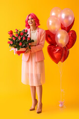 Stylish woman with bright hair, bouquet of flowers and air balloons on color background. Valentine's Day celebration