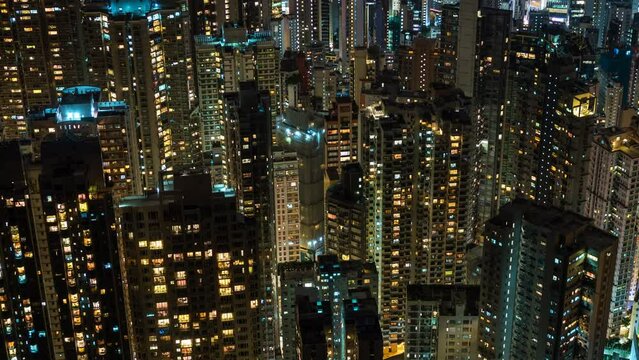 Zoom in time lapse view of residential buildings at night in Hong Kong, China, one of the most densely populated cities in the world.