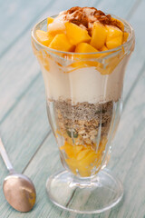 mango dessert in a milkshake glass