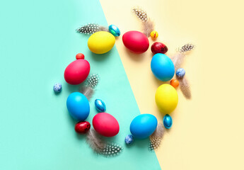 Frame made of multicolored Easter eggs on color background