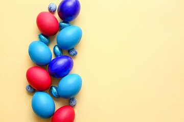 Different painted Easter eggs on light background
