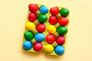 Holder with multicolored Easter eggs on light background