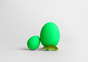 Green Easter eggs on light background