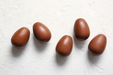 Delicious chocolate Easter eggs on white background