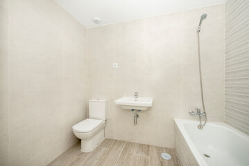 Fototapeta na wymiar Bathroom with stoic furnishings and tiling in light cream tones
