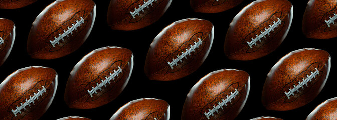 american football balls on black background