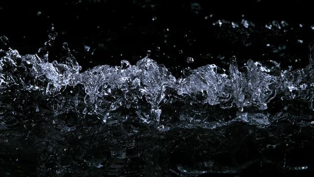Super Slow Motion Shot of Water Waves Linear Impact on Black Background at 1000fps.
