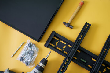 Bracket for wall mounting TV or computer monitor, an electric drill-driver, mounts and monitor...