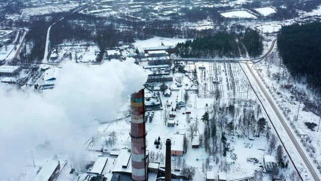 Smog smoke carbon and pollution emissions from industry smokestacks. Pollution of the atmosphere by an industrial enterprise of the TPS station.   Cinematic footage. Top view