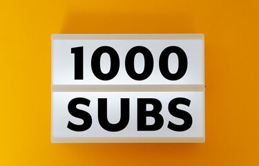 1000 subs number of subscribers text on yellow background - obrazy, fototapety, plakaty