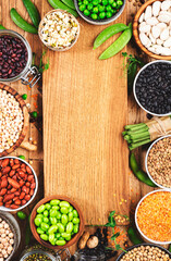Legumes, beans and sprouts. Dried, raw and fresh, top view. Red kidney beans, lentils, mung beans, chickpeas, soybeans, edamame, green peas, Healthy, nutritious, diet food, vegan protein