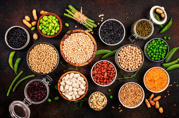 Legumes, beans and sprouts. Dried, raw and fresh, top view. Red kidney beans, lentils, mung beans, chickpeas, soybeans, edamame, green peas, Healthy, nutritious, diet food, vegan protein