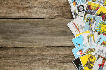 Tarot cards on wooden table, top view. Space for text - obrazy, fototapety, plakaty