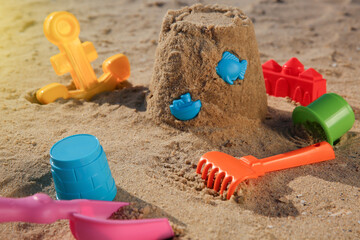 Set of plastic beach toys on sand. Outdoor play